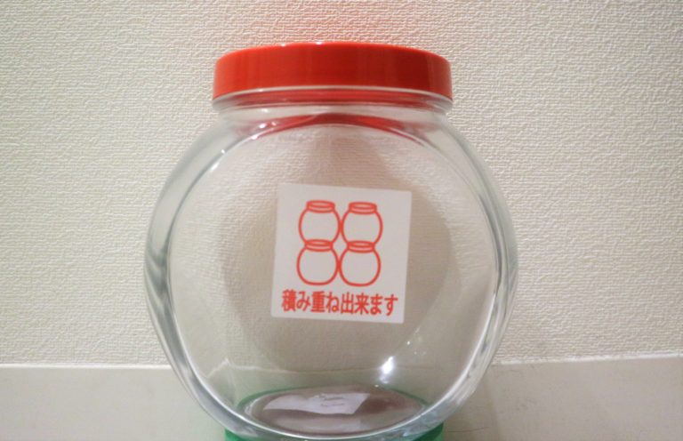 積み重ね出来ますと書かれた赤い蓋の丸い透明容器