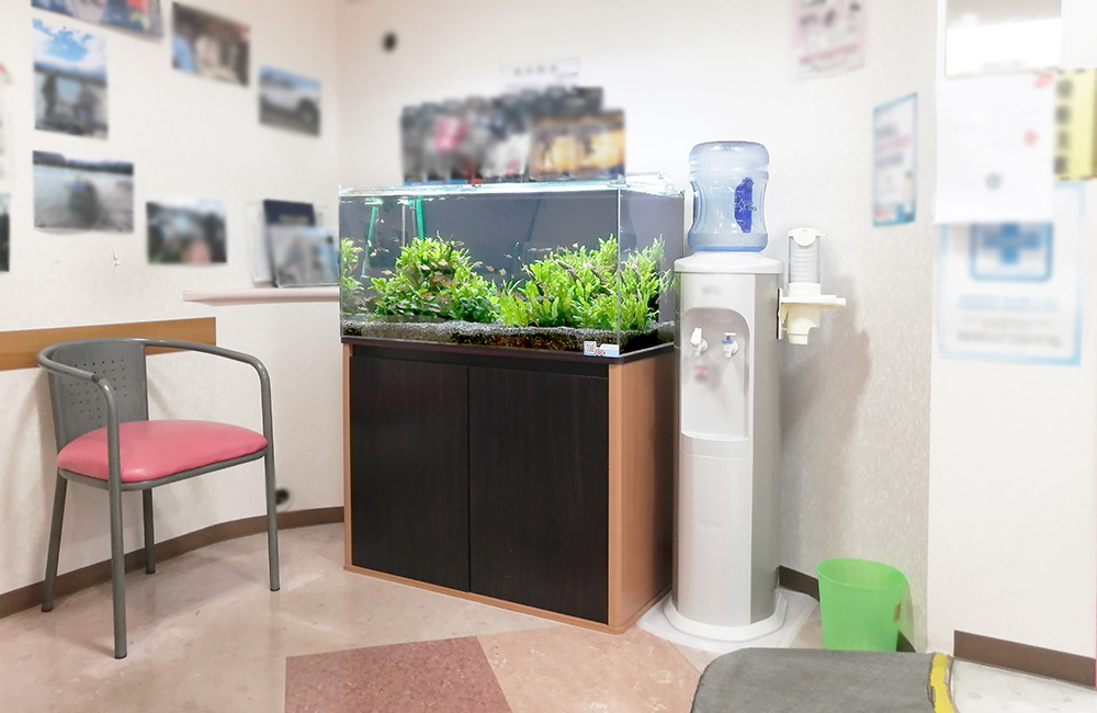 待合室に設置された水草水槽とウォーターサーバーの風景