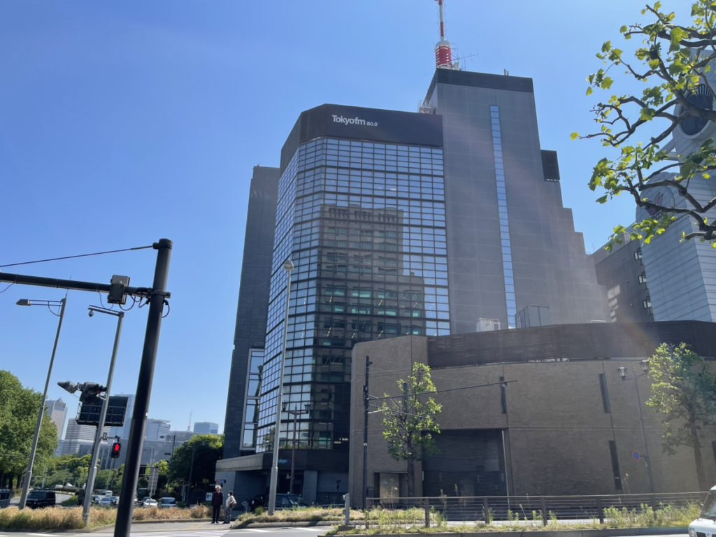 青空の下に建つTokyo fmロゴ入りのビル外観