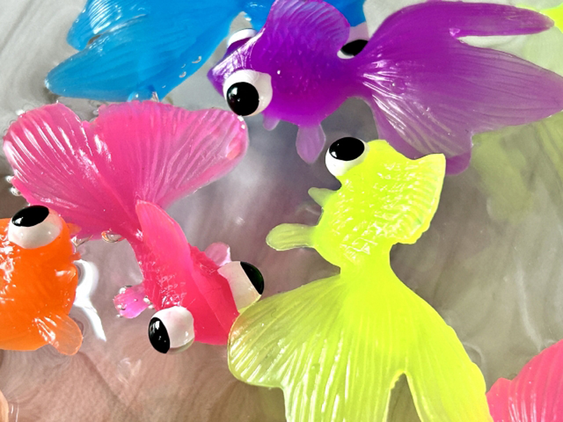 水面に浮かぶカラフルな金魚の形をした玩具